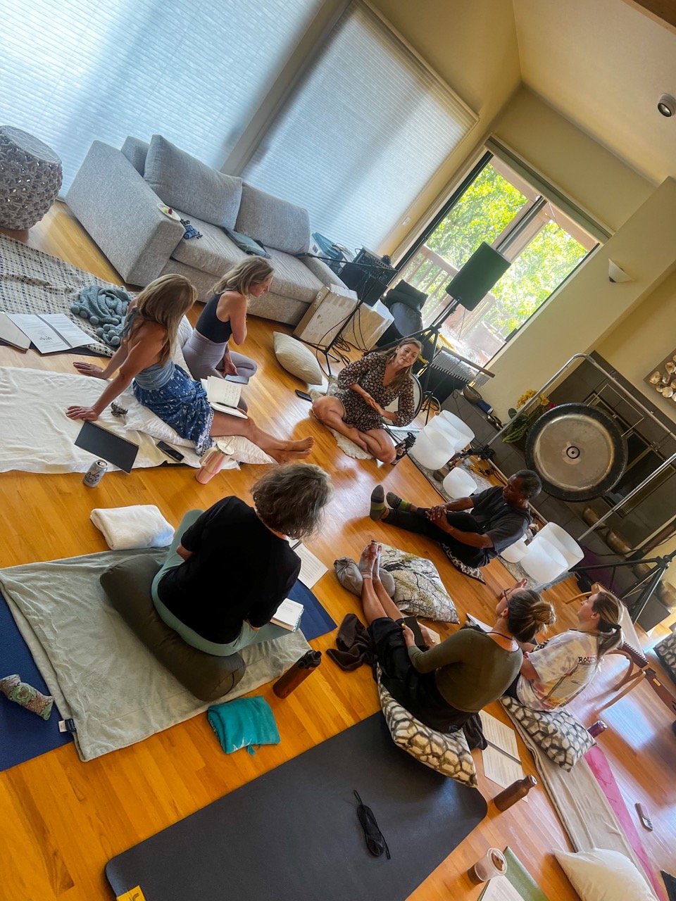 A group gathered for sound bath training in a living room